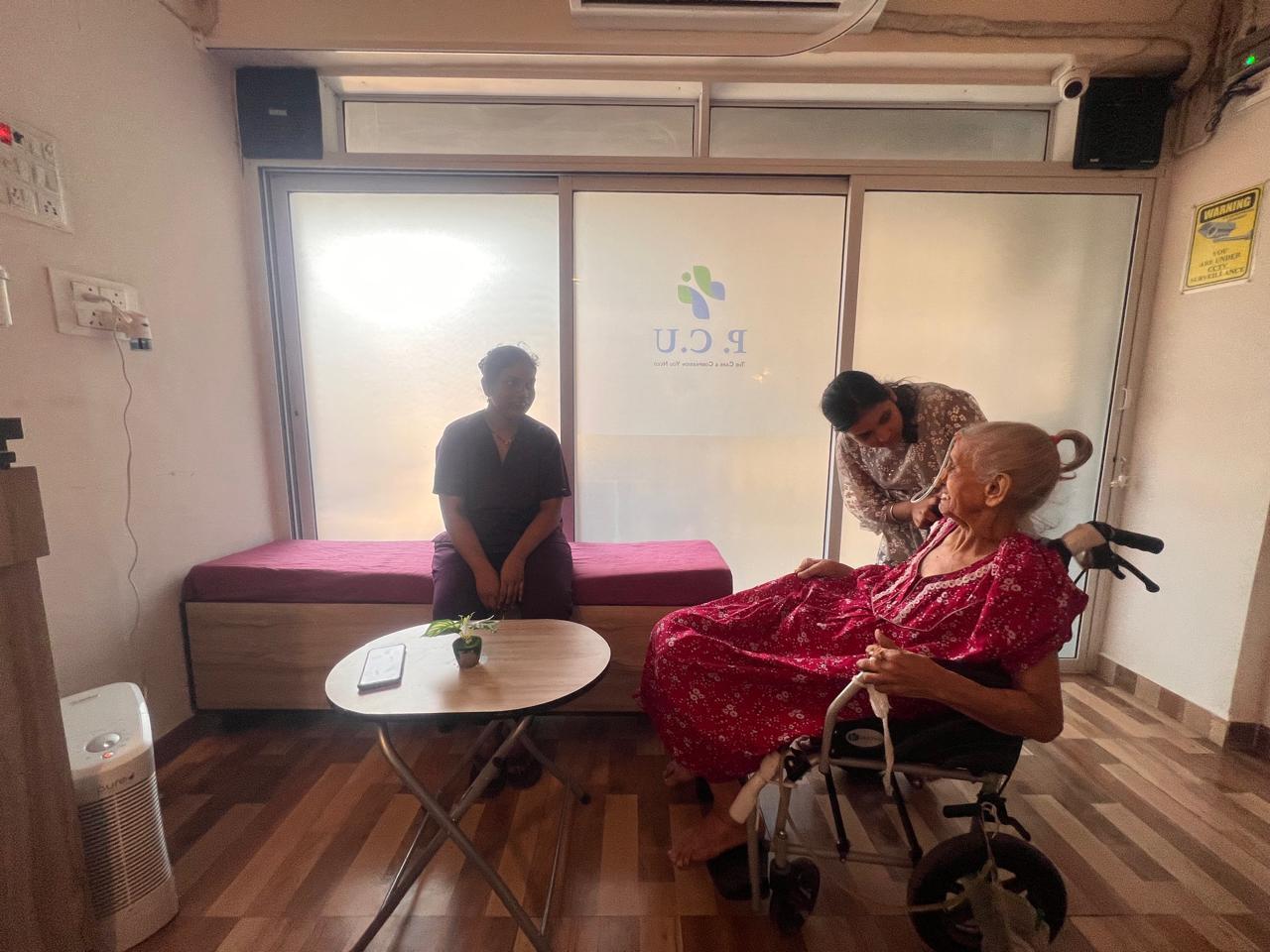 A caregiver gently tending to a senior resident